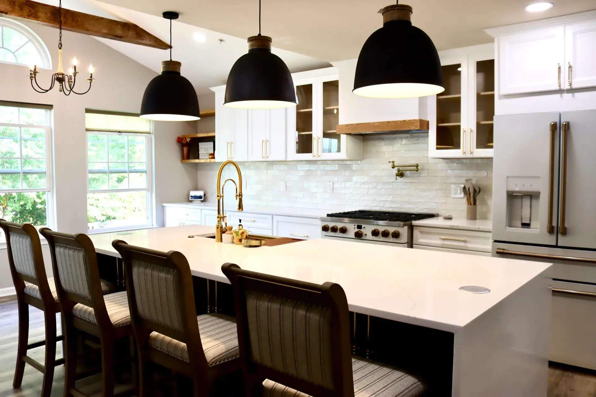 Open-concept kitchen remodel in Northern Virginia with luxury cabinetry, pendant lighting, and hardwood floors