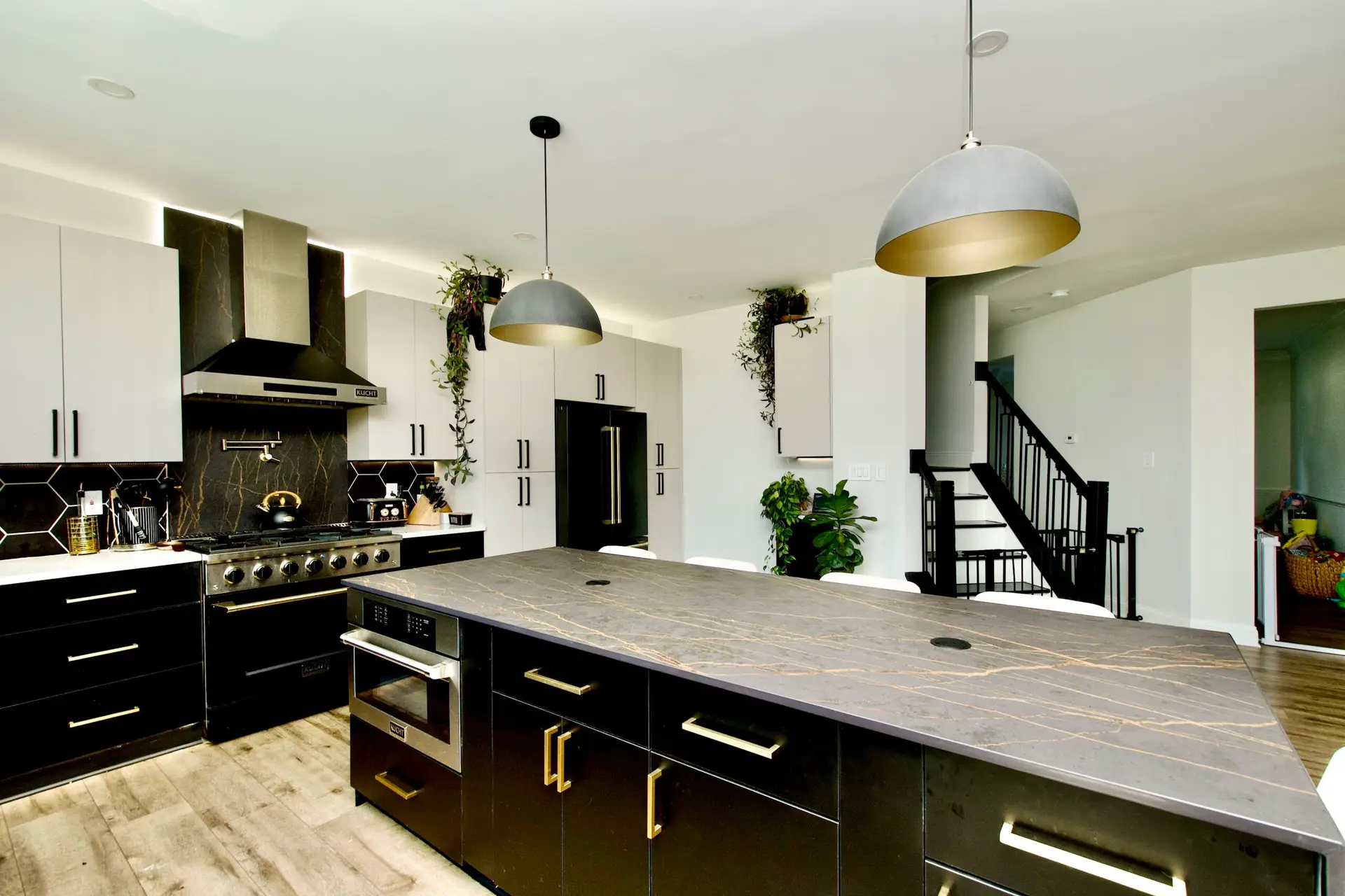 Warm modern kitchen renovation with statement island and layered lighting
