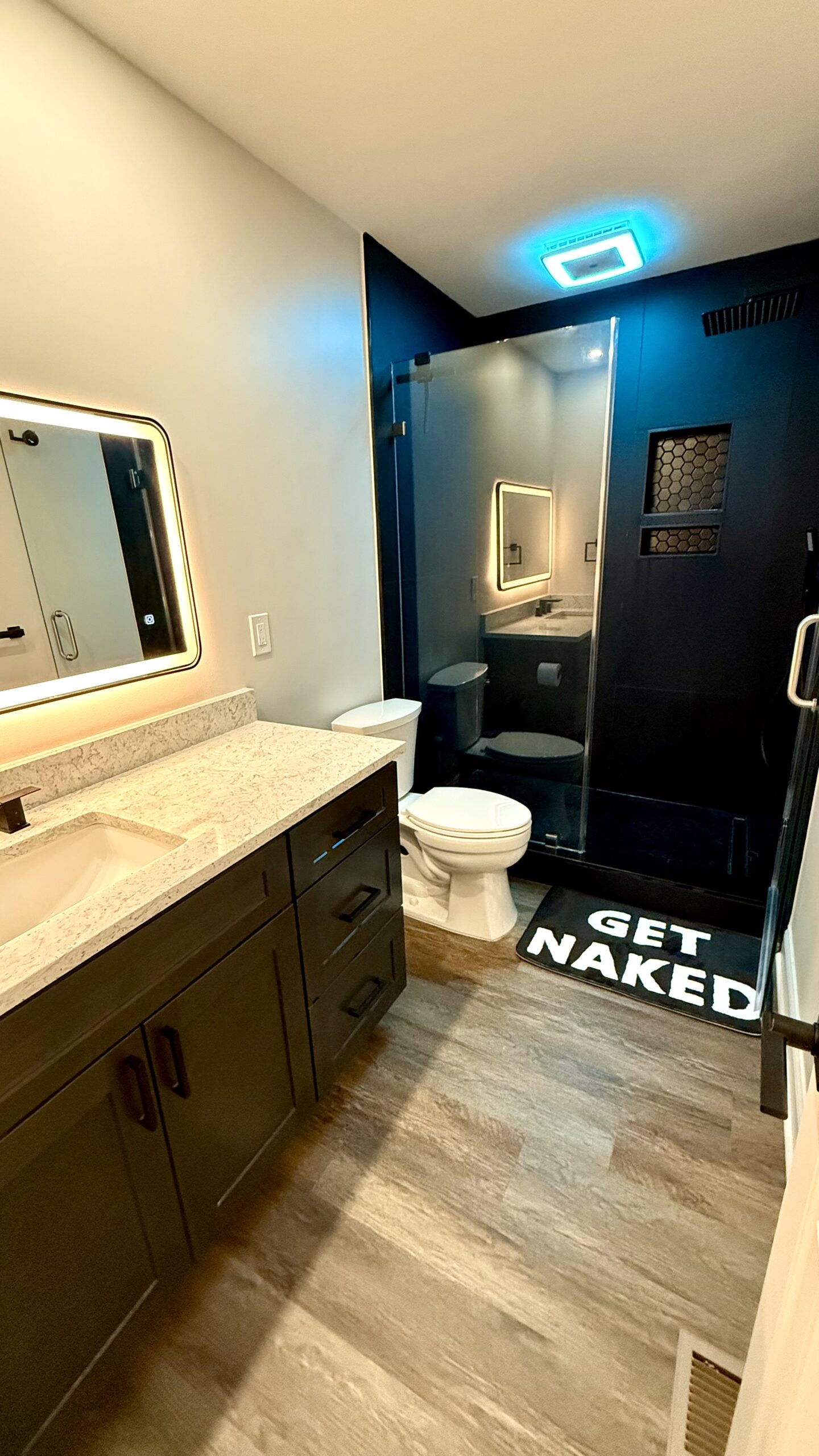 Completed modern luxe kitchen with full height quartz and island lighting