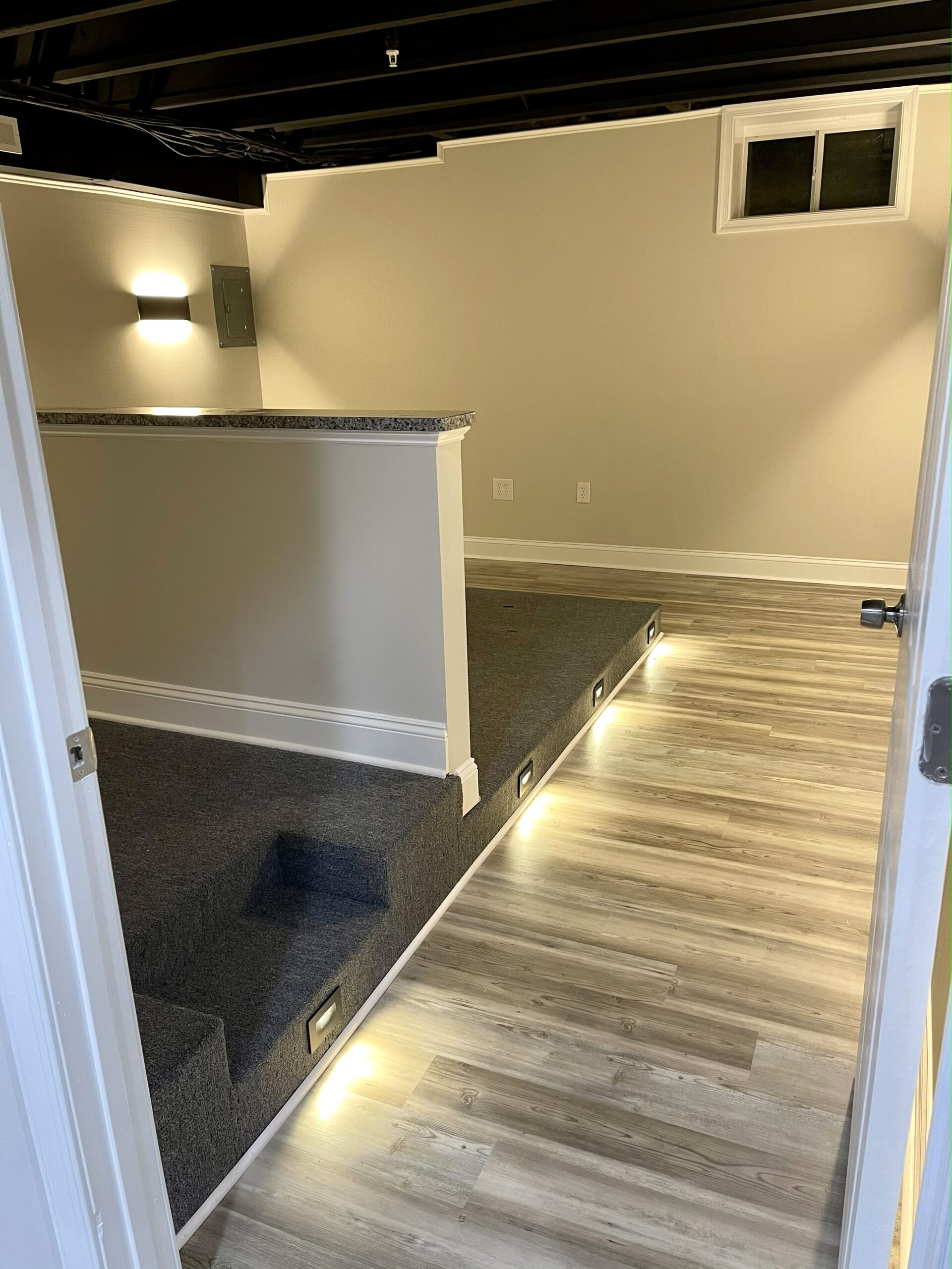 Basement seating vignette with art and recessed lighting