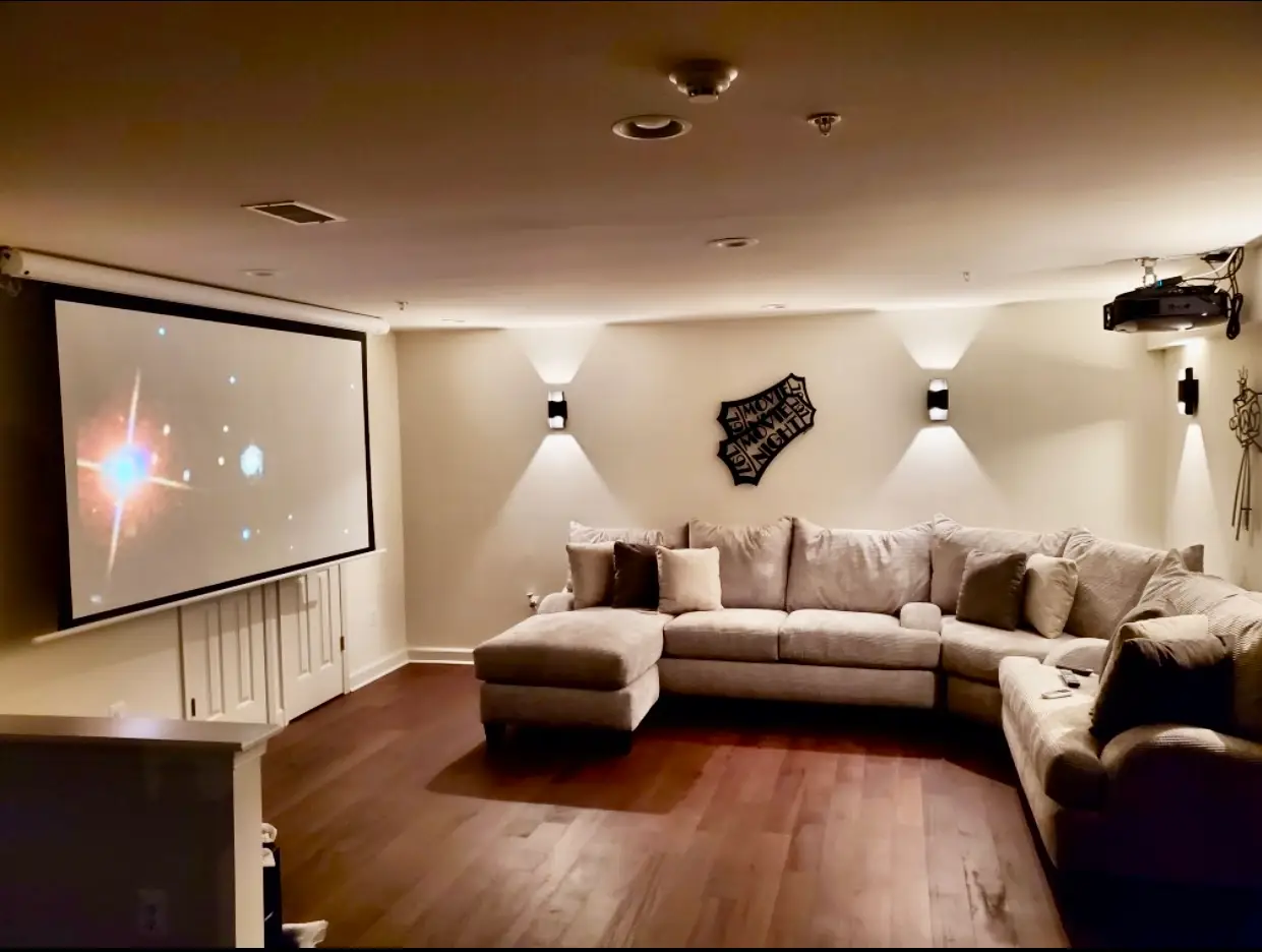 Basement family room with sectional and TV wall