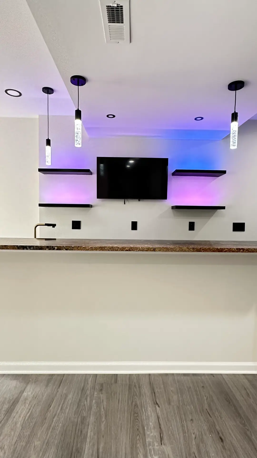 Basement seating area with warm lighting and built-ins