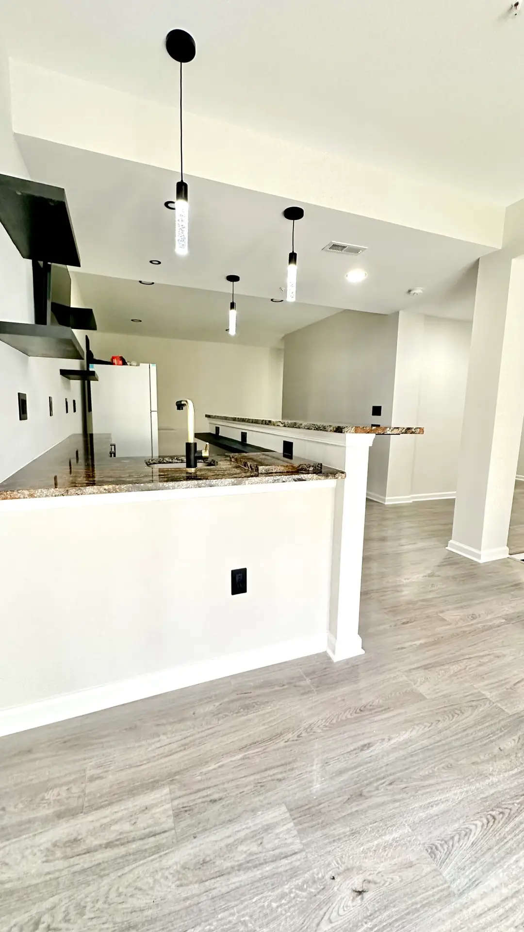 Finished basement living area with seating and warm lighting