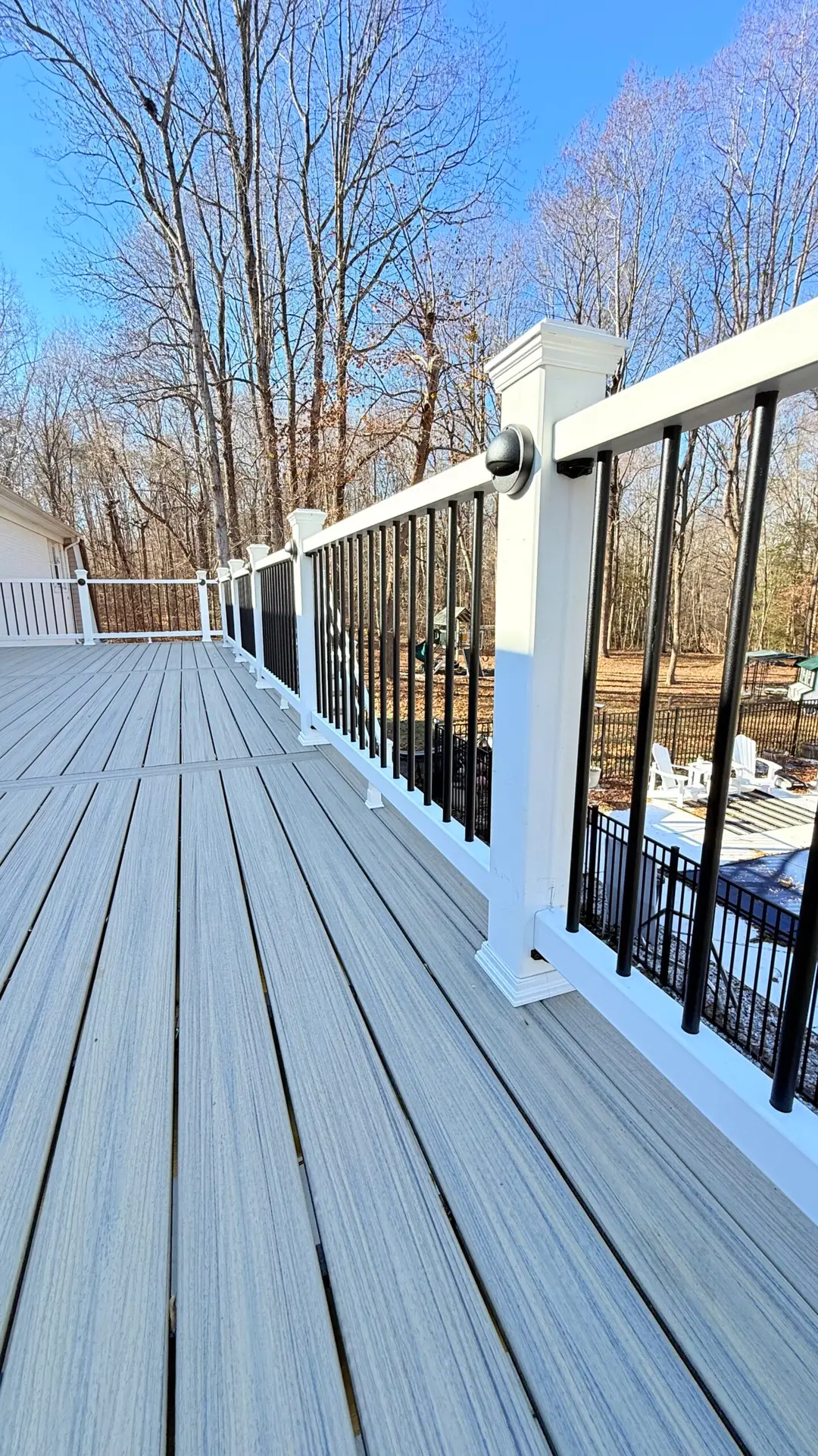 Deck staircase with white railing and black balusters in Warrenton, Virginia
