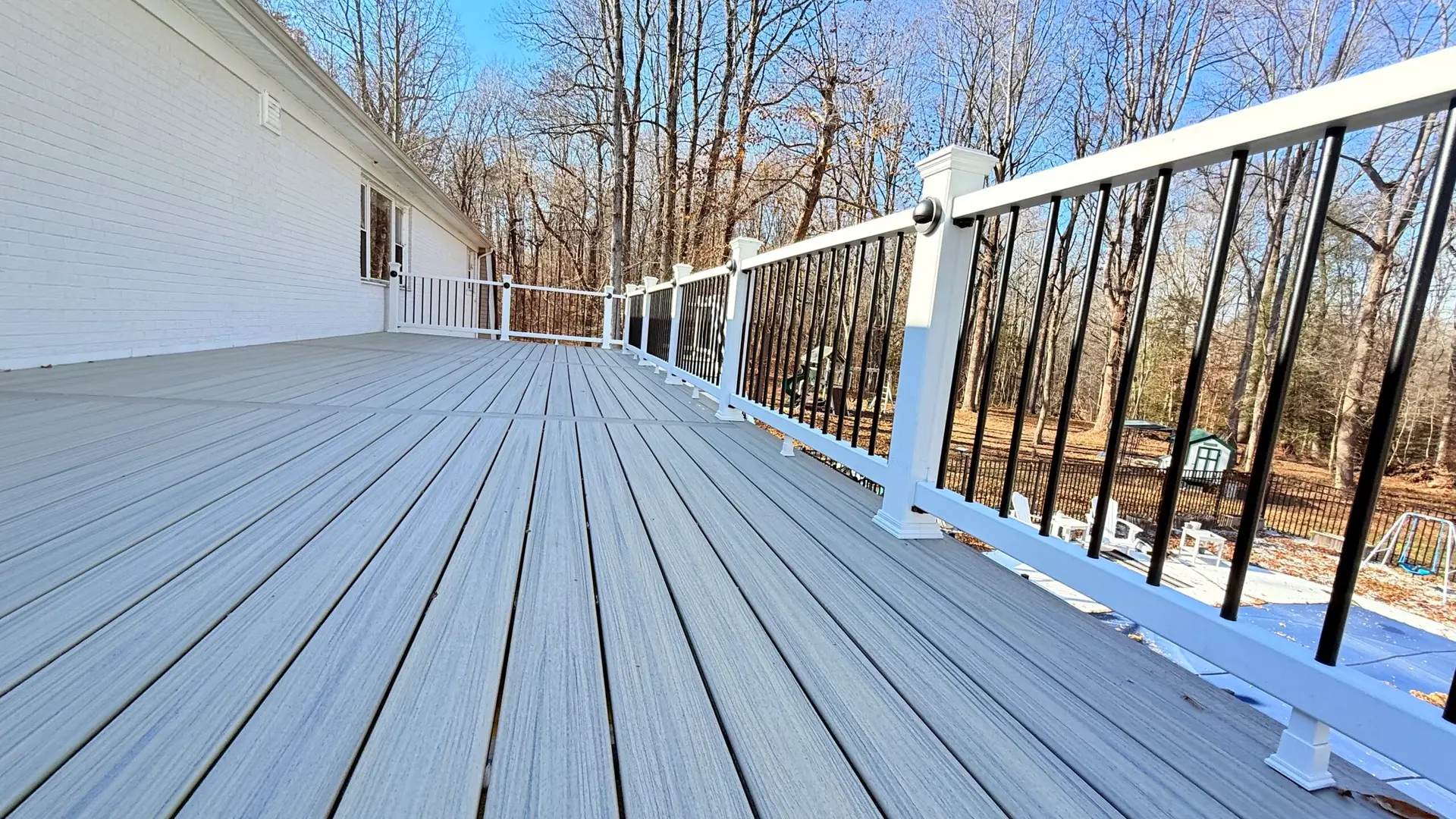 Elevated composite deck with white railing in Warrenton, Virginia backyard